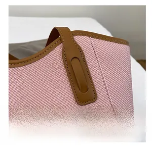 Detailed close-up of pink twill tote bag showing precise stitching and brown leather trim