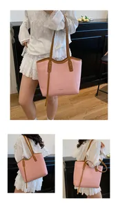 Macro shot of large pink tote bag with woven PU leather texture and brown strap details