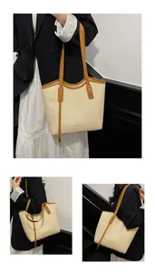 Macro detail of woven texture tote bag with contrasting tan trim and long shoulder straps