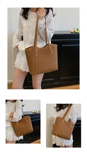 Detail view of large caramel tote bag with woven texture and gold fashion lettering