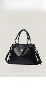 Detail of black lychee grain leather tote bag with sturdy handles and adjustable strap