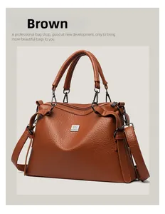 Detailed macro shot of a brown pebbled leather handbag with dual handles and logo