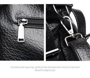 Close-up of black litchi pattern leather bag with silver metal zipper and lobster clasp