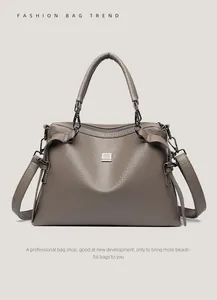 Detail of grey lychee textured leather tote bag with gunmetal hardware and sturdy handles