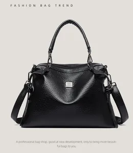 Detail of black pebbled leather texture on a stylish Boston handbag with silver hardware