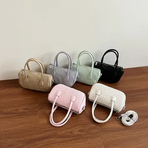 Minimalist pleated faux leather handbag available in six colors with adjustable straps