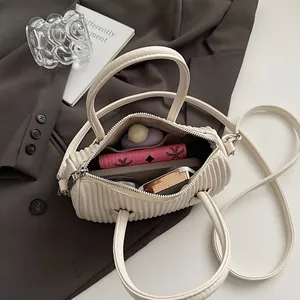 Chic cream pleated cloud crossbody bag with top handles and silver zipper closure