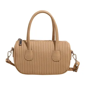 Retro beige pleated cylinder handbag with double handles and a detachable shoulder strap