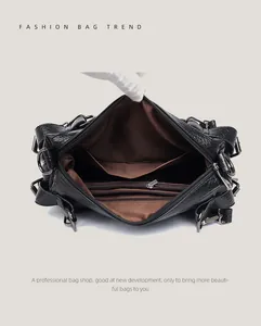 Detailed interior of black leather tote bag with brown lining and organized compartments