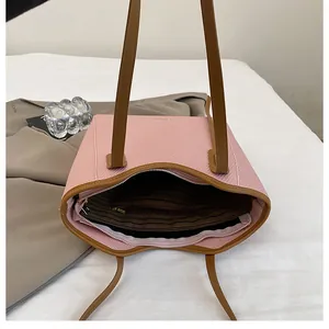 Detail view of pink tote bag showing inner zipper pocket and textured fabric texture