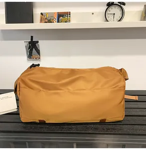 Dettaglio della borsa sportiva giallo senape in nylon resistente con tracolla regolabile