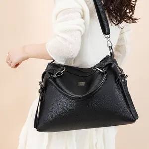 Women's black lychee pattern leather handbag with silver hardware and shoulder strap