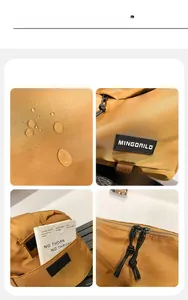 Dettaglio della borsa a tracolla kaki con tessuto impermeabile e doppie cerniere metalliche
