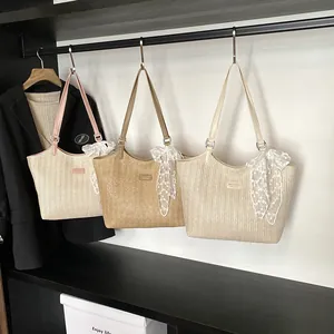 Three minimalist woven straw tote bags with leather straps and decorative lace bows
