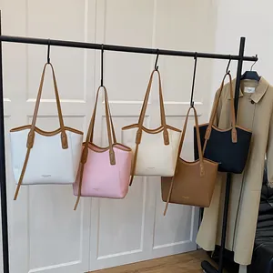 Minimalist tote bags in multiple colors hanging on a rack for a stylish boutique display