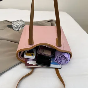 Pink large capacity tote bag with brown straps showing storage for tablet and umbrella