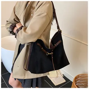 Retro tote bag in black matte fabric with brown leather straps shown on a model