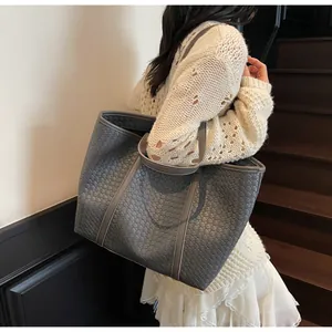 Detail of the high-quality woven texture on the large grey commuter tote bag