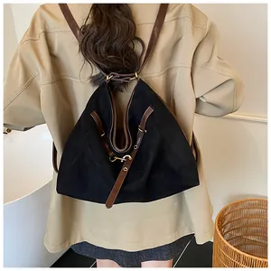 Detail of vintage tote bag with contrast brown leather straps and gold buckle accents