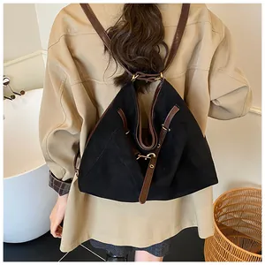 Detailed back view of a black frosted tote bag with brown leather shoulder straps