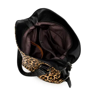 Leopard print tote bag with black leather trim showing spacious interior compartments