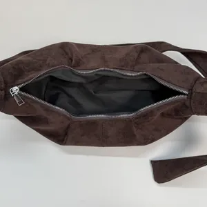 Deep brown suede slouchy dumpling bag with top zipper and spacious interior view