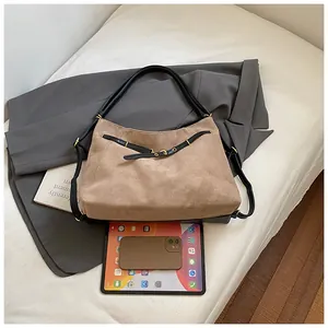 Detail of suede tote bag with tablet and phone showing large commuter capacity