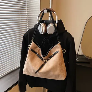 Macro shot of large tote bag with matte suede texture and elegant black straps