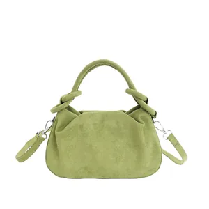 Grass green pleated shoulder bag in soft suede with a twisted top handle for women