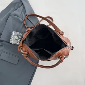 Brown vintage faux leather tote bag with internal pockets and silver-grey hardware detail