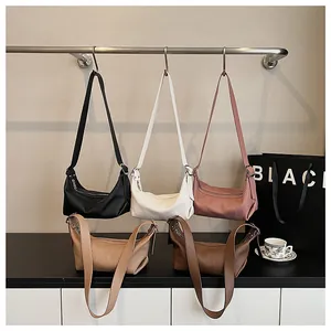 Detail of five-color crescent shoulder bags showing pleated texture and silver zippers