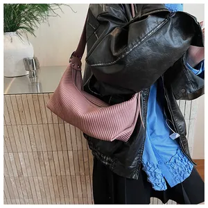Detailed texture of pink pleated hobo bag with sleek zipper and elegant crescent shape