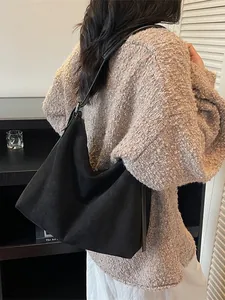 Grand sac cabas noir mat minimaliste présenté par un mannequin dans un cadre réel