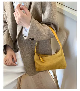 Chic mustard yellow suede handbag styled with a beige suit for a trendy daily look