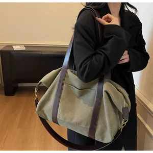 Detail of the army green canvas tote bag with adjustable brown leather shoulder straps