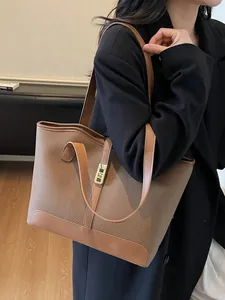 Classic brown pebble leather tote bag with gold metal clasp for office commuting