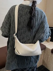 Chic beige ribbed crescent shoulder bag with adjustable strap for a trendy look