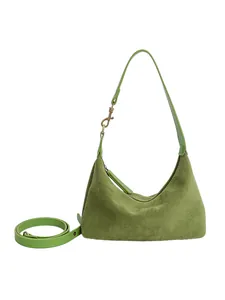 Grass green suede crescent shoulder bag with adjustable strap in a minimalist style