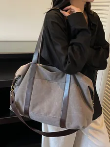 Minimalist large capacity canvas tote bag with brown leather handles for commuting