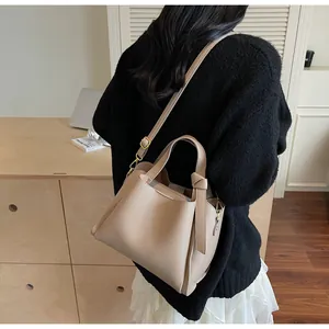 Litchi pattern leather bucket bag details with decorative knot and adjustable strap