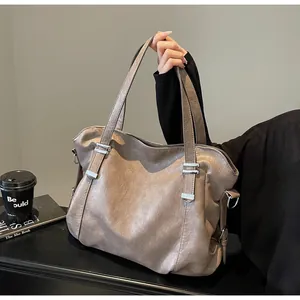 Detail of soft leather tote bag with silver metal studs and flat handles for daily commute