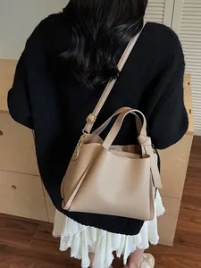 Elegant khaki bucket bag in litchi texture with dual handles and gold hardware details