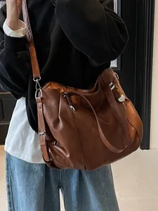 Retro brown oversized PU leather tote bag with silver rivets and adjustable strap