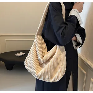 Detailed texture of a beige corduroy tote bag showing its soft ribbed fabric material