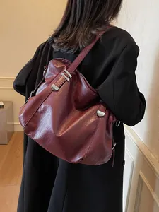 Large burgundy leather tote bag for women featuring silver hardware and a minimalist design