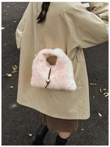Detail of pink and white gradient fuzzy plush bag with elegant gold bead and leather cord