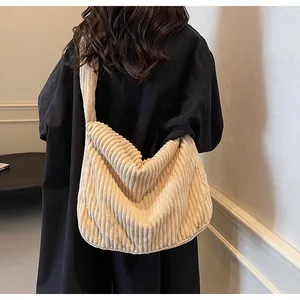 Detail of off-white corduroy tote bag showing soft texture and wide shoulder strap