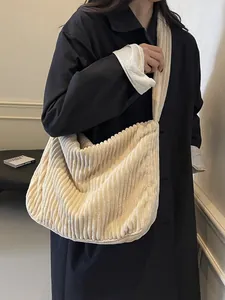 Large capacity off-white corduroy tote bag worn as a crossbody shoulder bag on a model
