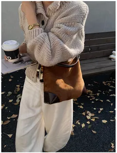 Foto exterior de bolso tote grande de ante con esquinas de cuero y cuentas de madera