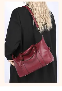 Close-up of burgundy lychee-grain leather tote bag with elegant metallic studs